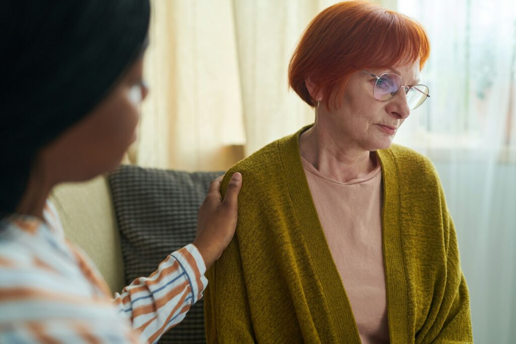 Caregiver with senior woman in nursing home